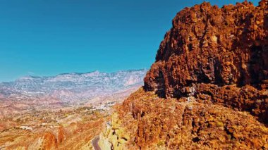 Hava perspektifi, Gran Canaria 'nın dramatik kayalık arazisini ve eşsiz jeolojisini gözler önüne seriyor. Canlı renkler bu İspanyol adasının güzelliğini vurguluyor..
