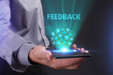 İş, teknoloji, Internet ve ağ kavramı. Geleceğin sanal bir ekranda çalışan genç bir girişimci ve yazıt görür: geribildirim