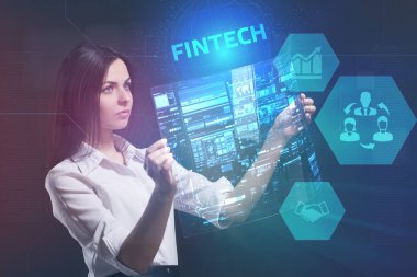 İş, teknoloji, Internet ve ağ kavramı. Geleceğin sanal bir ekranda çalışan genç bir girişimci ve yazıt görür: Fintech