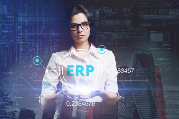 The concept of business, technology, the Internet and the network. A young entrepreneur working on a virtual screen of the future and sees the inscription: ERP