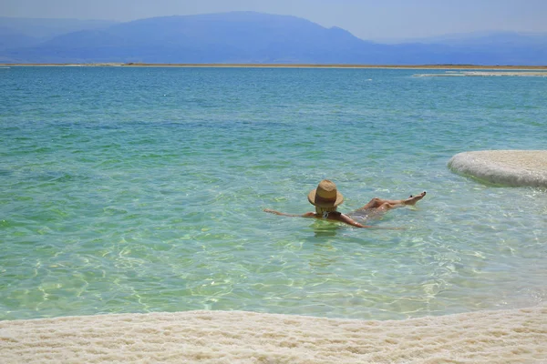 Girl relaxing in the water of Dead Sea
