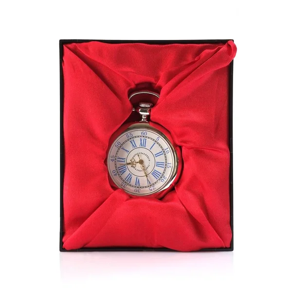 Pocket watch in box with red silk isolated on white background