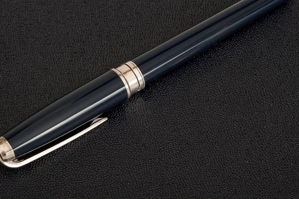 Silver ball pen isolated on black background