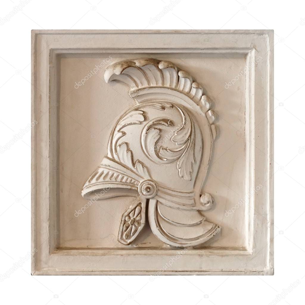 White marble element of the interior with the image of the helmet from the ancient Greek myth. The element is isolated on white background