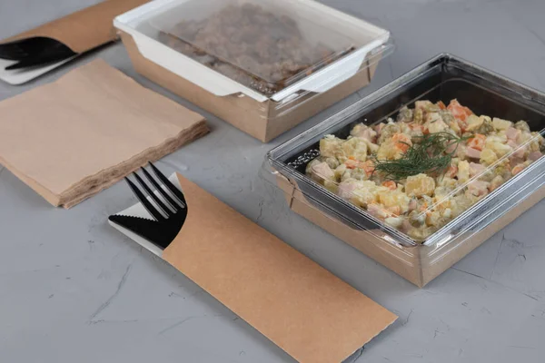 Food in eco packaging - Olivier salad for delivery.