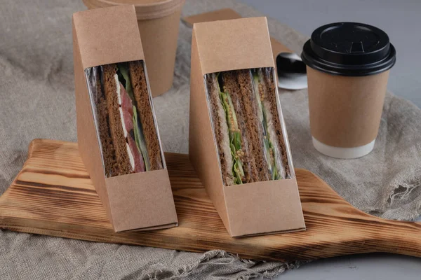 Eco-friendly coffee and sandwiches with fresh vegetables, tuna, salmon and herring paste. Vegan food.