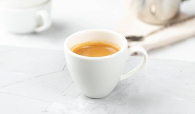 Beton arka planda küçük bir fincan sıcak espresso.