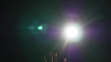 İnsan erkek el jest dramatik projektör Parlatıcı ray veya ışın ile siyah arka plan üzerinde spotlight veya arka ışık ışık koşullarında yükseltilmiş parmak ile karanlık siluet