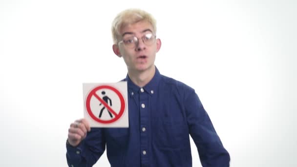 Young man holding signs people are not allowed to enter on a white background — Stock Video