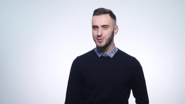 Closeup portrait of a young smiling man sending a kiss — Stock Video