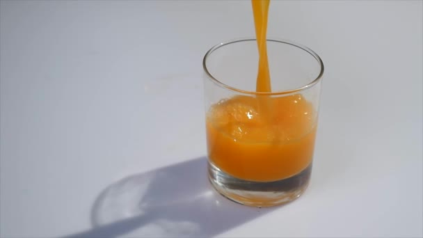 Orange Juice Pours Into Glass — Stock Video