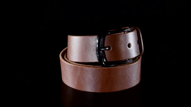 Brown mens belt rotate on a black background — Stock Video
