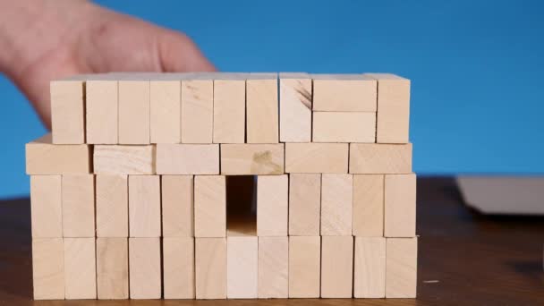 Mani di Young costruisce una torre di blocchi mentre gioca jenga — Video Stock