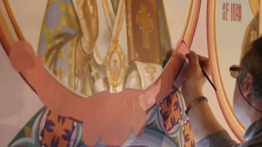 30.01.2018, Chernivtsi, Ukrayna - erkek sanatçı olduğunu ayakta ve simge, Ortodoks bir palet ile boyar Holding Saint, boyama