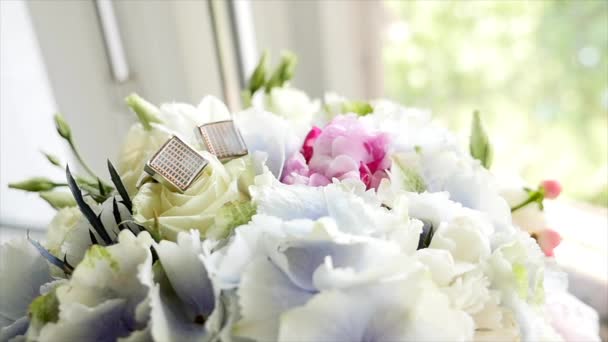 Cufflinks on Bouquet of the bride background — Stock Video