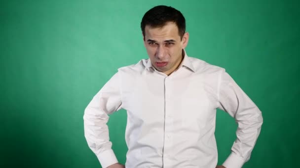 Portret van de jonge man dronken of ziek braken op groene achtergrond — Stockvideo