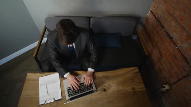 Businessman using laptop in cafe on wood table. top view — Stock Video