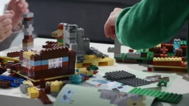 Childs'ın elleri bir küçük lego tuğla, Hands yakın Up oynamaya. LEGO inşaat oyuncak popüler bir çizgidir