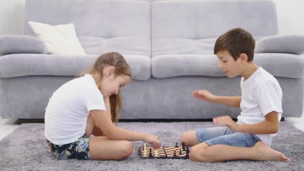 Παιδιά που παίζουν σκάκι που κάθεται στο πάτωμα στο δωμάτιό τους — Αρχείο Βίντεο