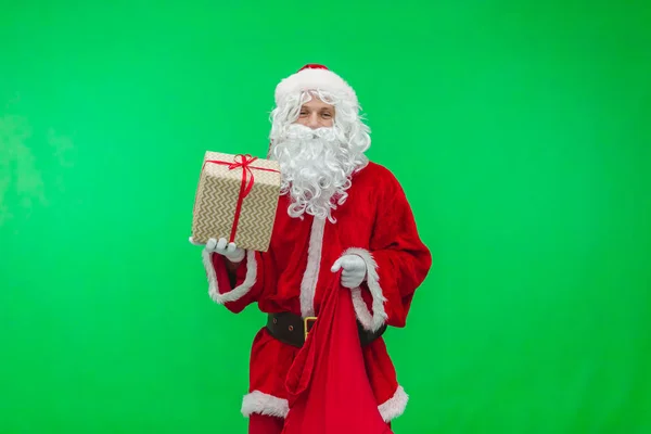 Santa Claus gets gifts from the bag. chroma key