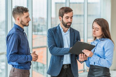 Sekreter belgeleri içeren bir klasör için imza getirdi.