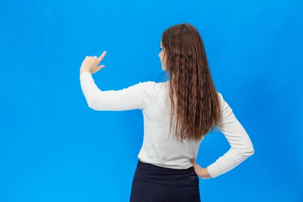 Young beautiful girl isolated on blue background — Stock Photo, Image