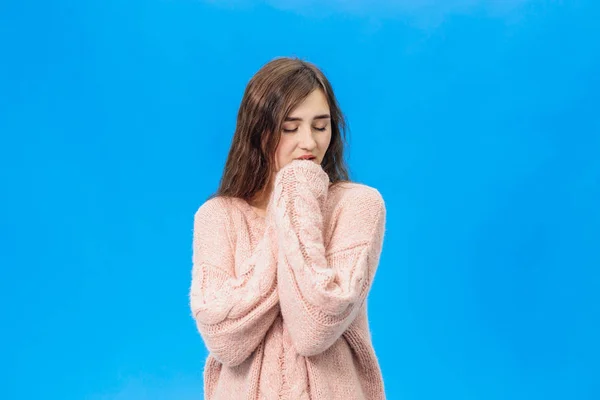 Young beautiful girl isolated on blue background