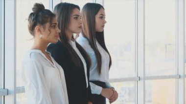 Memnuniyetle, üç iş kadın kolları, kameraya bakarak çapraz. Giymiş beyaz bluz.