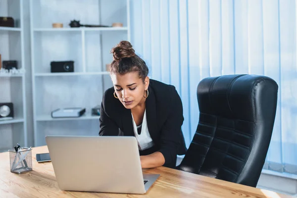 Young business lady working at a computer is tired.