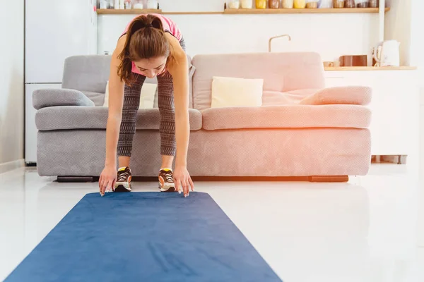 Young girl doing stretching exercise Nice graceful girls with long hair in pantyhose occupied by yoga on a lilac carpet. — Stock Photo, Image