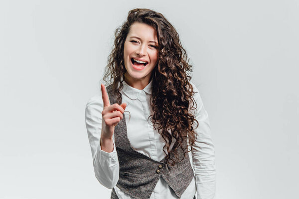 A young man with a white shirt with his hand expressing not a positive attitude.