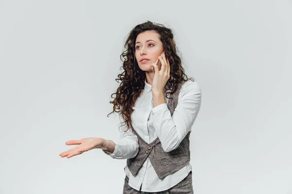 Jeune femme d'affaires avec de beaux cheveux bouclés sur un fond blanc . — Photo