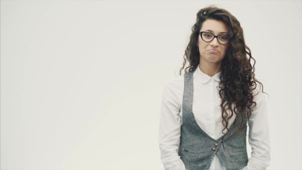 Young energetic cute business girl stood on a white background in glasses. — Stock Video