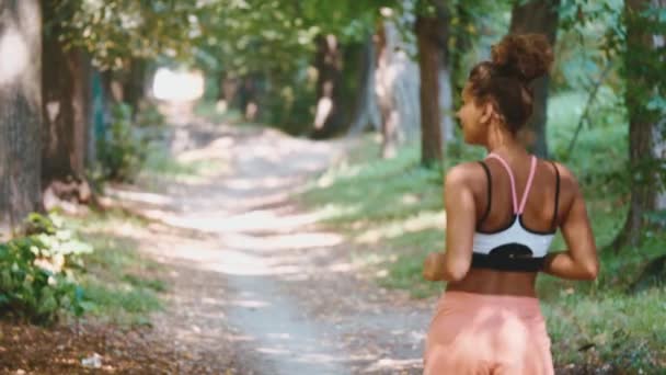 Young fitness woman running at forest trail. — Stock Video