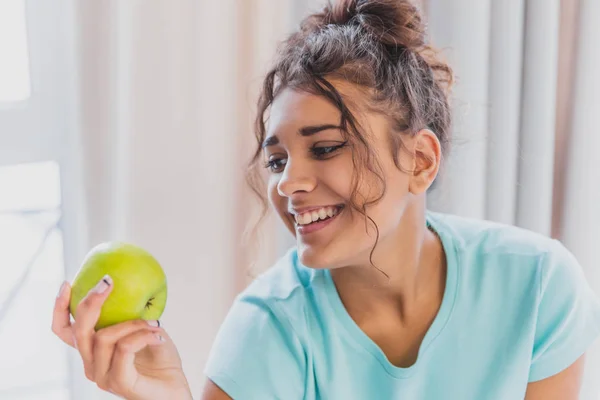 Woman eating apple. Healthy nutrition. Diet. Young woman is eating apple. Healthy eating concept. Vegetarian, vegan, raw concept.