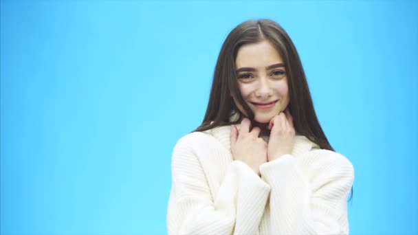 Portrait of cute morning girl. Beautiful cheerful teen girl looking at camera over blue background. Young woman posing in pajamas at studio. — Stock Video