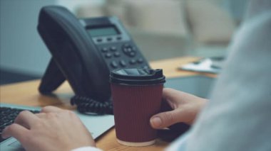 Bir dizüstü bilgisayar kullanarak bir iş modern kadının yaşam tarzı. Çalışma eller. Bir Online Web sitesi okuma. İş kavramı. Bu süre boyunca, kahve içmek.