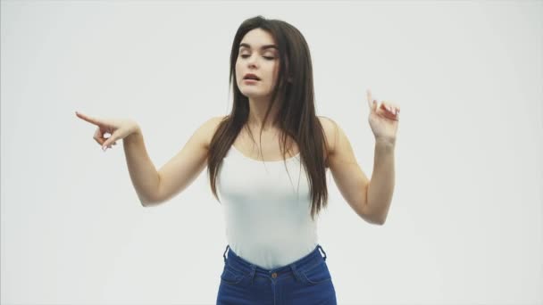 Gestures of a young beautiful girl on a white background. Different hand gestures and tongue. Show emotions. — Stock Video