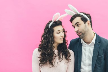 Genç çift ayakta pembe bir arka plan üzerinde güzel. Aynı zamanda eşi sevgi dolu bir göz bir adam bakar, o zaman onun karısı kocası görünüyor. Paskalya.