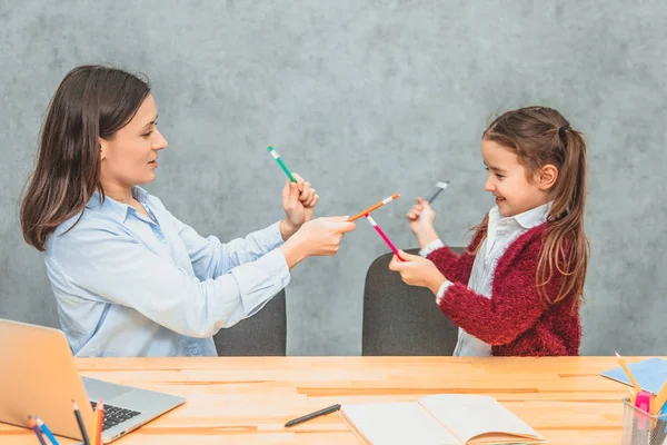 Máma a dcera spolu tráví čas. Během této barevné tužky hrají hru. Veselá rodina. — Stock fotografie