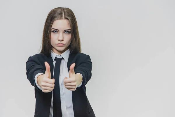 Female hand gestures thumbs up. Business girl is serious and shows her confidence. — Stock Photo, Image