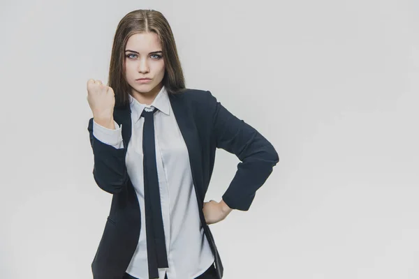 Hardwerkend mooie bruin harige vrouw toont haar vuist, bedreigend op hetzelfde moment, is geïsoleerd, op de witte achtergrond. Ruimte kopiëren. — Stockfoto