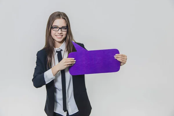 Young woman is holding a yellow speech bubble close to herself, which is rectangular-shaped, isolated, on the white background. Young lady is looking at the camera and presenting violet speech bubble. — Stock Photo, Image