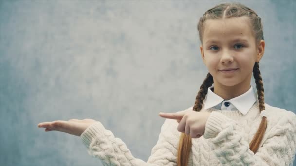 Schoolgirl is presenting a kind of project and pointing at something important. — Stock Video