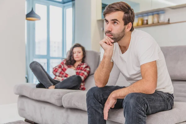 Stel argumenteren. De vrouw schreeuteerde naar haar wanhopige man, zittend op de Bank in de woonkamer thuis. Een man kijkt niet naar zijn vrouw. — Stockfoto