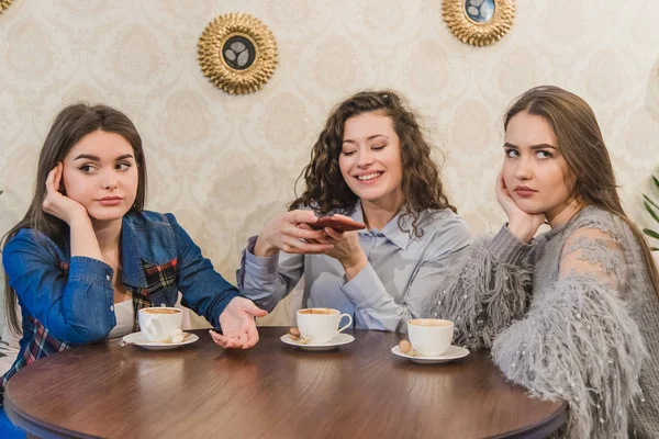 Female friends having a coffee together. Three women at cafe drinking, talking, laughing and enjoying their time. Lifestyle and friendship concepts with real people models. — Stock Photo, Image