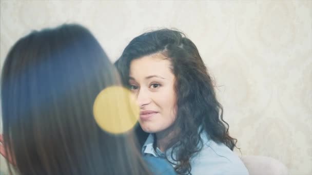 Hübsche junge Frauen in einem Café sitzen. eine schöne und warme Aufnahme eines kaukasischen Mädchens in lässiger Kleidung durch ein Fensterglas. — Stockvideo