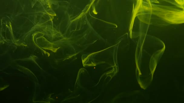 Φυσικός ατμοσφαιρικός κίτρινος καπνός που αιωρείται χαοτικά στο σκούρο-πράσινο φόντο. — Αρχείο Βίντεο