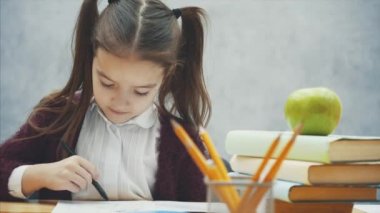 Gri geçmişi olan bir kız öğrenci. Bu süre zarfında o masada oturur ve bir not defteri alır.