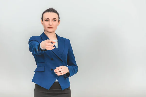 Female teacher standing, pointing her finger at the camera, looking strict and decisive. — ストック写真